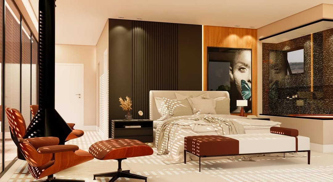 The en-suite — black river pebble feature wall at the shower, read against the pale vanity zone and brass fixtures.